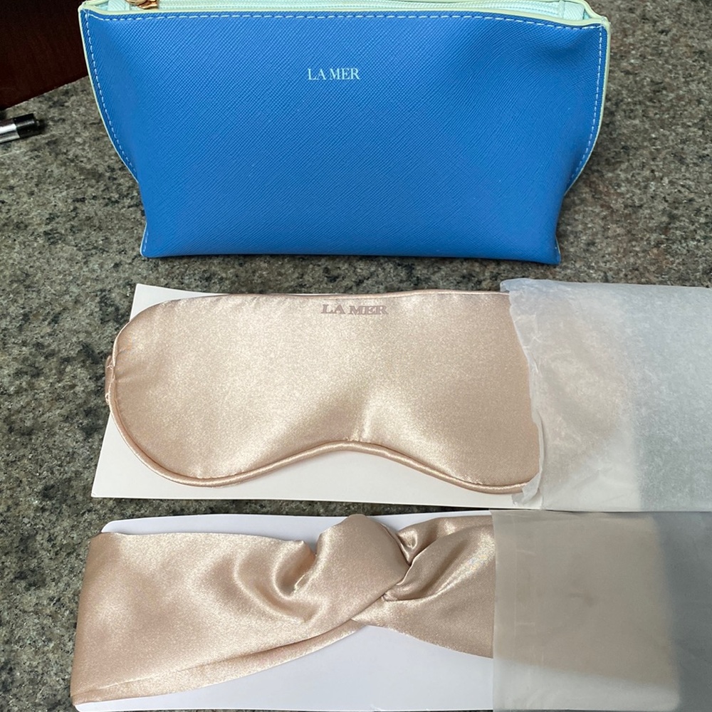 La Mer cosmetic bag, silk eye mask, and silk headband